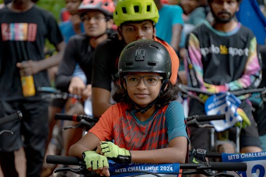 A young female biker ready for the MTB Challenge 2024 race, surrounded by fellow participants.