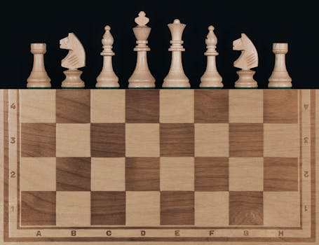 Seven wooden chess pieces arranged on a wooden chessboard with a black background.